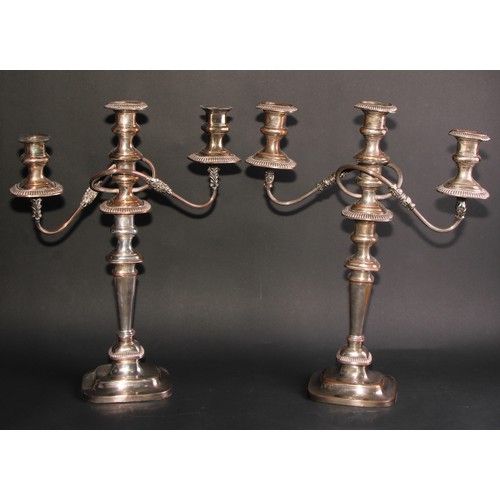 292 - A near pair of George IV Old Sheffield Plate rounded rectangular table candelabra, fluted borders, d... 