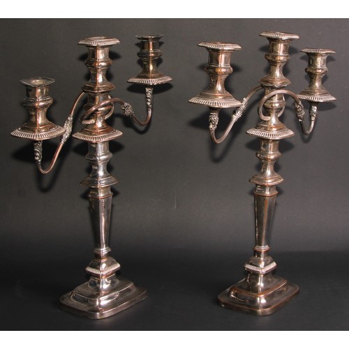 292 - A near pair of George IV Old Sheffield Plate rounded rectangular table candelabra, fluted borders, d... 