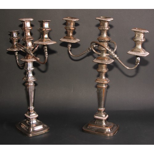 292 - A near pair of George IV Old Sheffield Plate rounded rectangular table candelabra, fluted borders, d... 