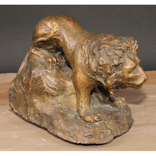 621 - Modern British School, a gilt patinated terracotta maquette, of a lion, 25cm long