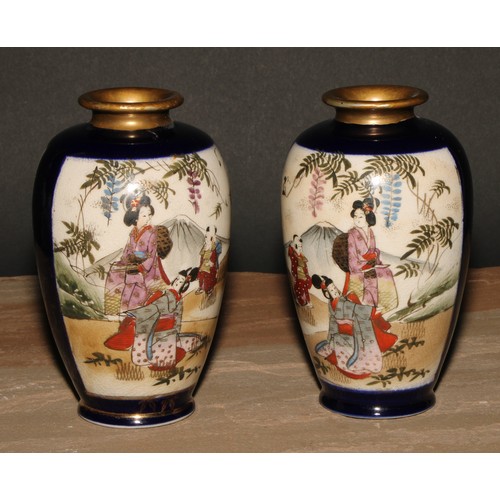 335 - A pair of Japanese satsuma ovoid vases, painted with geishas in a landscape, 14.5cm high, early 20th... 