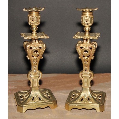 328 - A pair of French gilt metal table candlesticks, cast throughout with scrolls and acanthus, canted sq... 