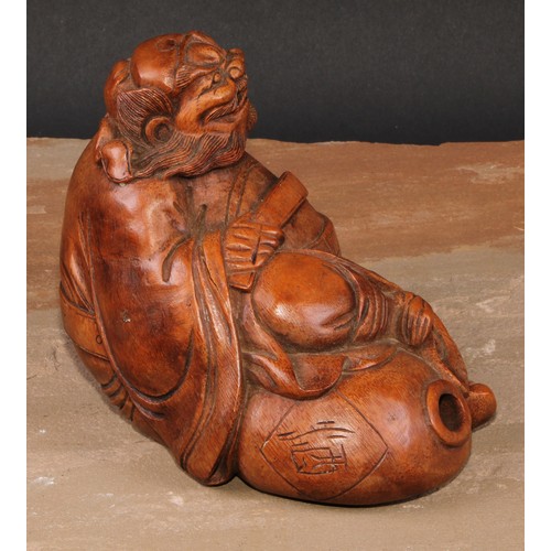 138 - A Chinese bamboo figure, carved as an elder seated on a gourd, 14.5cm high