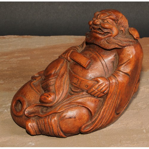 138 - A Chinese bamboo figure, carved as an elder seated on a gourd, 14.5cm high