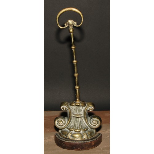 19 - A 19th century brass and cast iron door stop or porter, cast with lotus and scrolls, posted handle, ... 