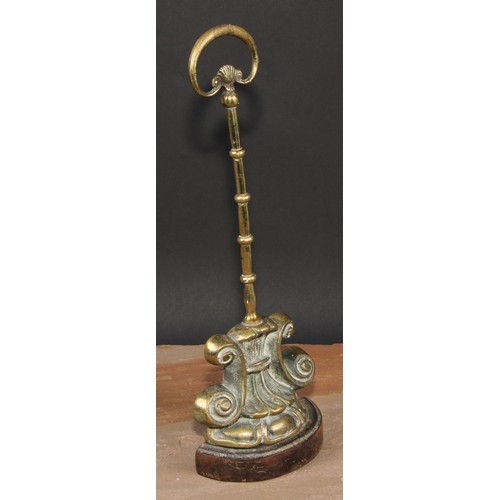 19 - A 19th century brass and cast iron door stop or porter, cast with lotus and scrolls, posted handle, ... 