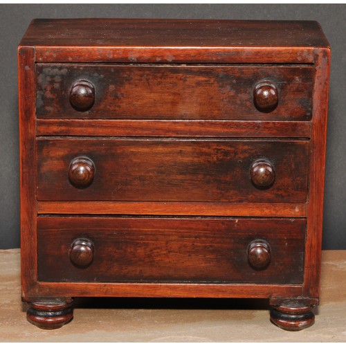 473 - An early Victorian rosewood miniature chest of drawers, flush top above three long graduated drawers... 