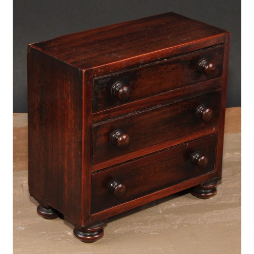 473 - An early Victorian rosewood miniature chest of drawers, flush top above three long graduated drawers... 