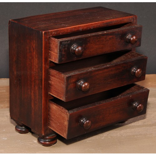 473 - An early Victorian rosewood miniature chest of drawers, flush top above three long graduated drawers... 