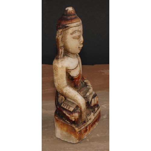 136 - A Chinese alabaster Buddha, seated, calling the Earth to witness, traces of painted and gilt decorat... 