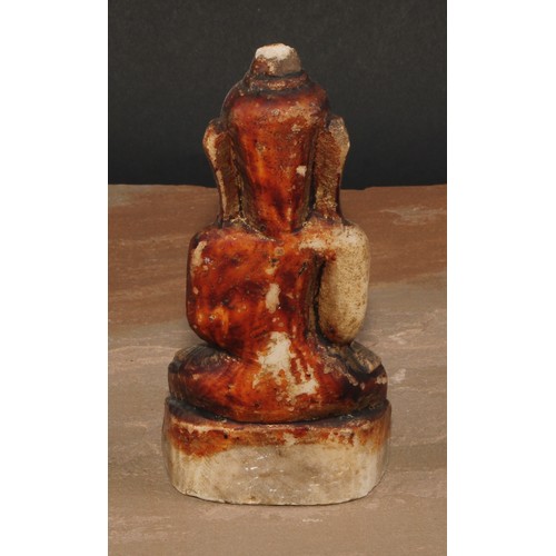 136 - A Chinese alabaster Buddha, seated, calling the Earth to witness, traces of painted and gilt decorat... 