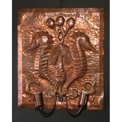 439 - An Arts and Crafts copper wall sconce, repousse chased in the manner of Newlyn with a pair of seahor... 