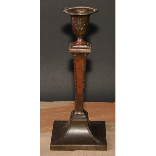 419 - An Adam Revival bronze candlestick, in the Neo-Classical taste with batwing paterae and bell husk sw... 