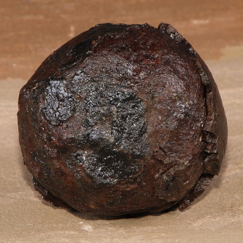 485 - An excavated iron canon ball, 9cm diam