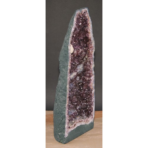 793 - Natural History - Geology - a large amethyst geode 'grotto', bisected to display matrix, 50cm high