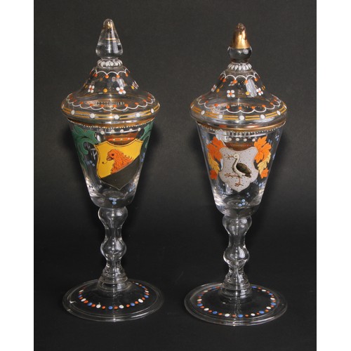 324 - A pair of Continental glass goblets and covers, each decorated in polychrome enamels with armorials ... 