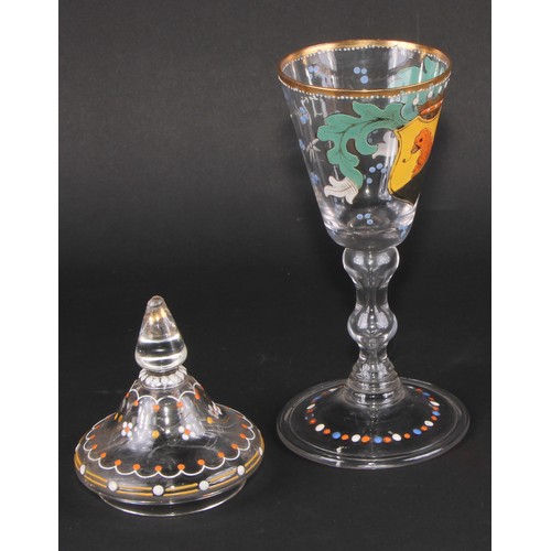 324 - A pair of Continental glass goblets and covers, each decorated in polychrome enamels with armorials ... 