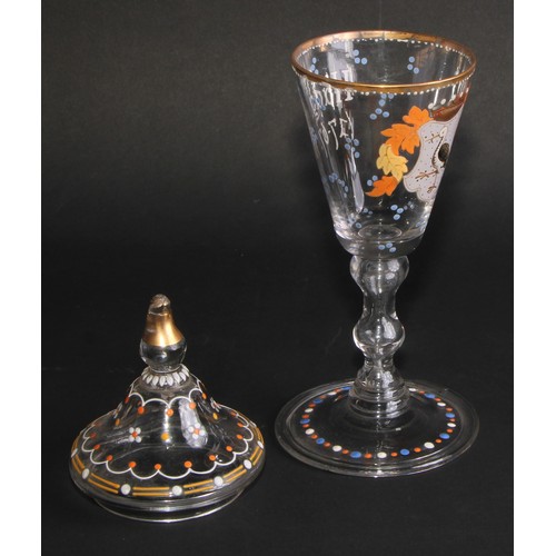 324 - A pair of Continental glass goblets and covers, each decorated in polychrome enamels with armorials ... 