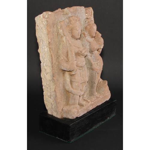 867 - Antiquities - an Indian pink sandstone stele, carved in bold relief with deities, 32cm high, c.11th/... 