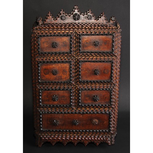 267 - A late 19th century tramp art wall cabinet, shaped cresting above a door applied with six faux drawe... 