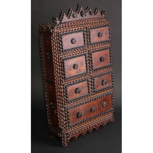 267 - A late 19th century tramp art wall cabinet, shaped cresting above a door applied with six faux drawe... 