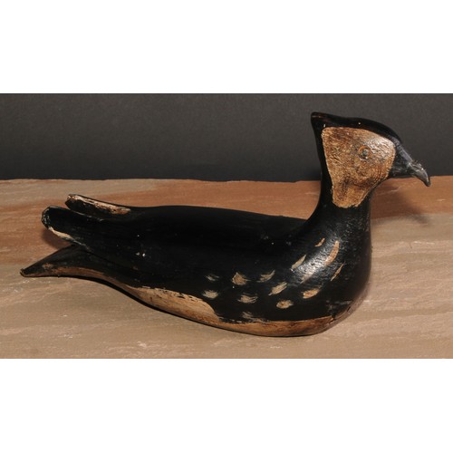 301 - A painted softwood avian decoy, carved as a waterfowl, 28cm long