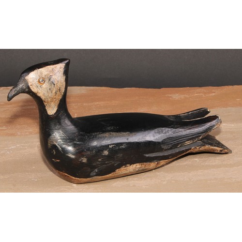 301 - A painted softwood avian decoy, carved as a waterfowl, 28cm long