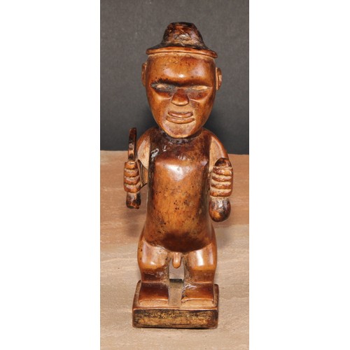 827 - Tribal Art - a Bembe Biteki figure, he stands, holding a knife and a gourd, 16cm high