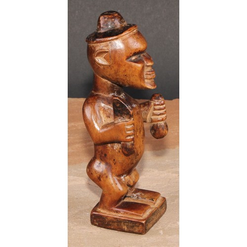 827 - Tribal Art - a Bembe Biteki figure, he stands, holding a knife and a gourd, 16cm high