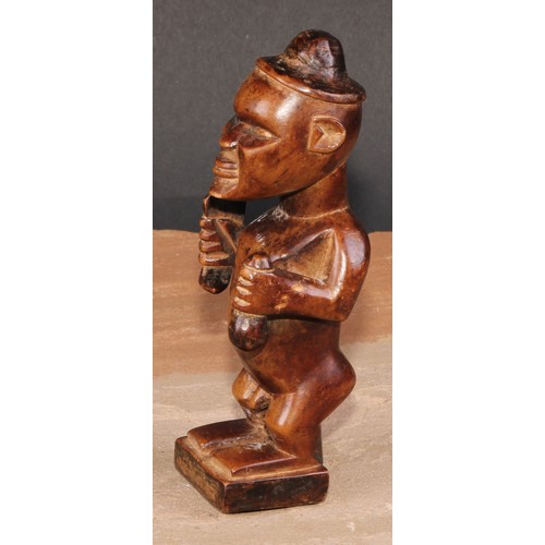 827 - Tribal Art - a Bembe Biteki figure, he stands, holding a knife and a gourd, 16cm high