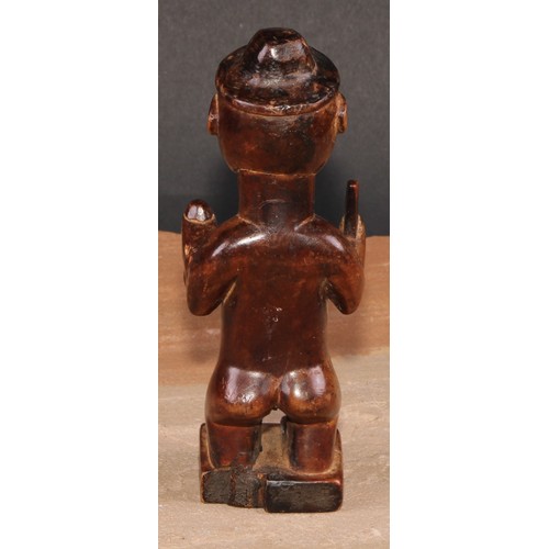 827 - Tribal Art - a Bembe Biteki figure, he stands, holding a knife and a gourd, 16cm high