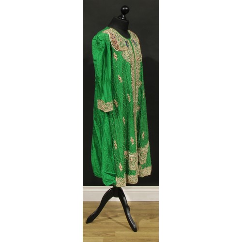 490 - An Indian emerald silk robe, worked in gilt and ruby thread with stylied lotus and 'peacock' motifs,... 