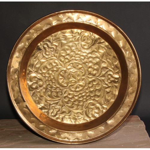 126 - A brass alms dish, chased with scrolling leaves, 45cm diam