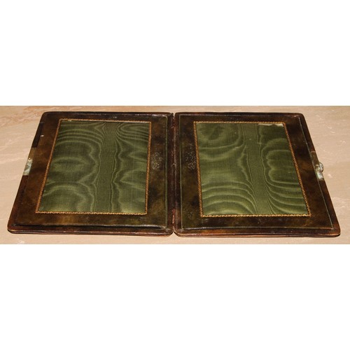 468 - An early 20th century tooled green leather travelling diptych photograph frame, 23.5cm high, c.1910