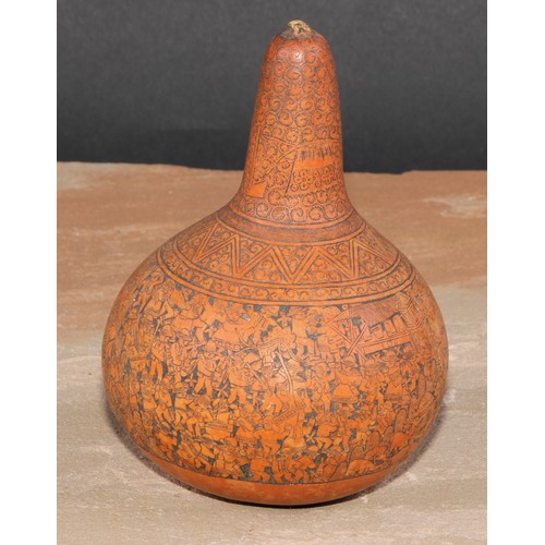 373 - A South American gourd, engraved with densely congregated figures, 13cm high