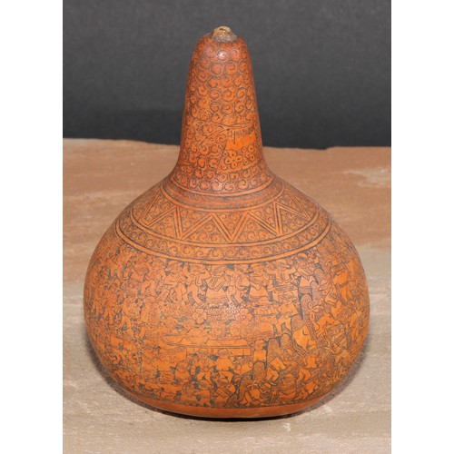 373 - A South American gourd, engraved with densely congregated figures, 13cm high