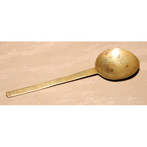 415 - An 18th century brass spoon, 24cm long