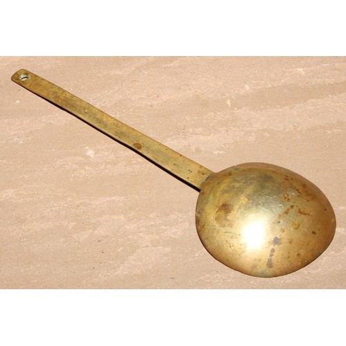 415 - An 18th century brass spoon, 24cm long