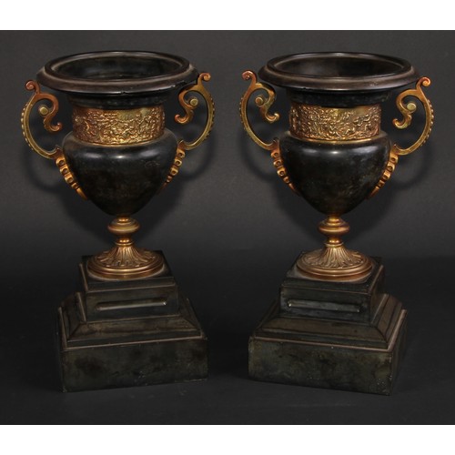 311 - A pair of 19th century gilt metal mounted black marble campana mantel urns, each with turned rim abo... 