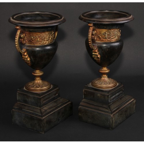 311 - A pair of 19th century gilt metal mounted black marble campana mantel urns, each with turned rim abo... 