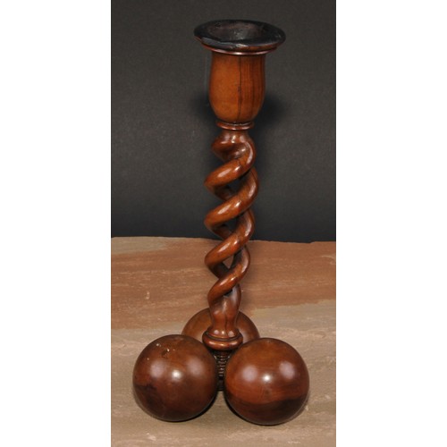 341 - A pair of Middle Eastern olivewood open-twist candlesticks, each triform base composed of three sphe... 