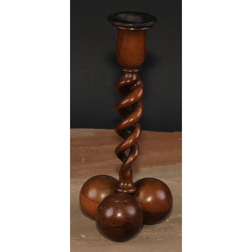 341 - A pair of Middle Eastern olivewood open-twist candlesticks, each triform base composed of three sphe... 