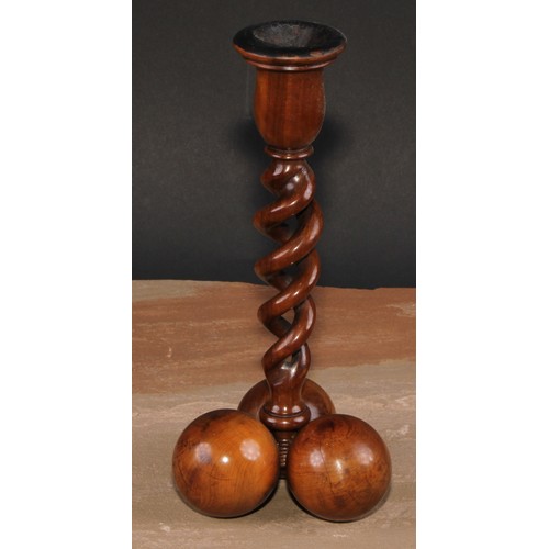 341 - A pair of Middle Eastern olivewood open-twist candlesticks, each triform base composed of three sphe... 