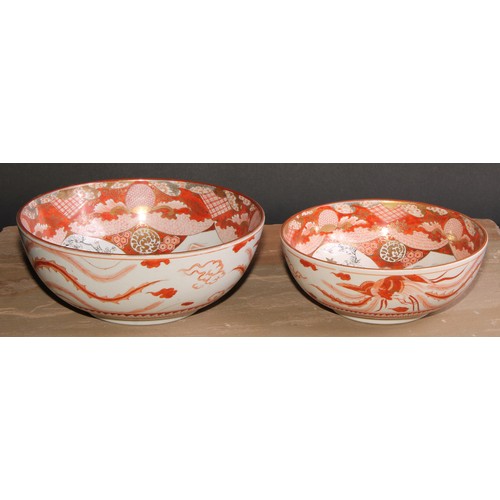 233 - A graduated pair of Japanese kutani bowls, decorated with figures and landscapes within assymetrical... 