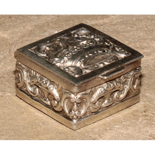 196 - A Continental silver coloured metal pill box, hinged cover embossed with a crown, the sides with taz... 