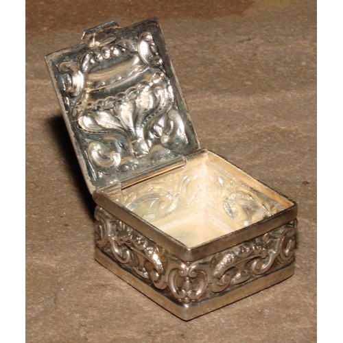 196 - A Continental silver coloured metal pill box, hinged cover embossed with a crown, the sides with taz... 