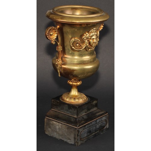 294 - A Neo-Classical Revival brass campana mantel urn, applied with a cast mask, scroll handles terminati... 