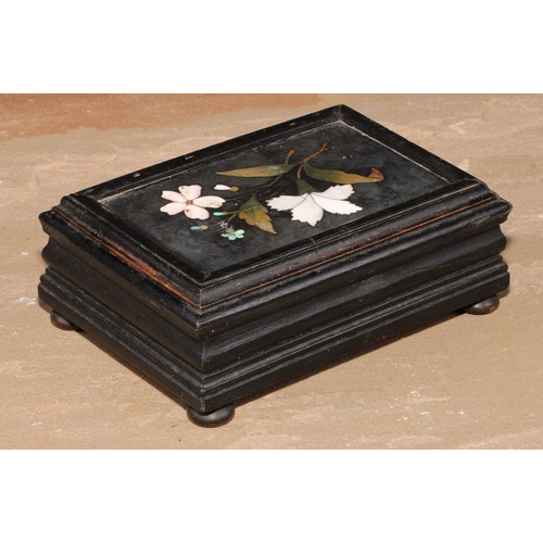 500 - An Italian pietra dura and ebonised casket, hinged cover set with a panel inlaid with a spray of flo... 