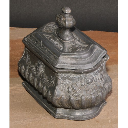 214 - A French lead half-fluted bombe shaped tobacco box, in relief with Baroque masks and swags, skirted ... 