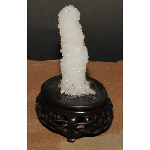 769 - Geology - a stalagtite specimen, mounted for the scholar's table, Chinese hardwood base, 9.5cm high ... 